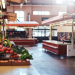 Sesonal vegetable market with variety of agriculture products on the shelfs and in the boxes.
